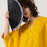 Elegant women’s handheld fan in black with minimalist striped trim and contemporary resort-inspired aesthetic.