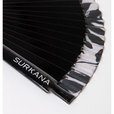 Trendy fashion accessory featuring black pleated folding fan and elevated summer street style look.