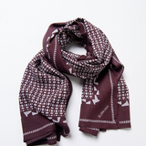 Women’s burgundy printed scarf by Surkana with cream geometric motifs and decorative border for modern casual outfits.