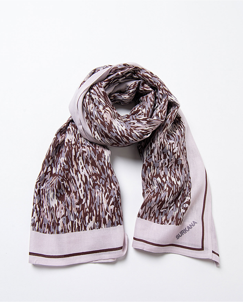 Boutique-style statement scarf with muted earth tones and elevated boho luxe aesthetic
