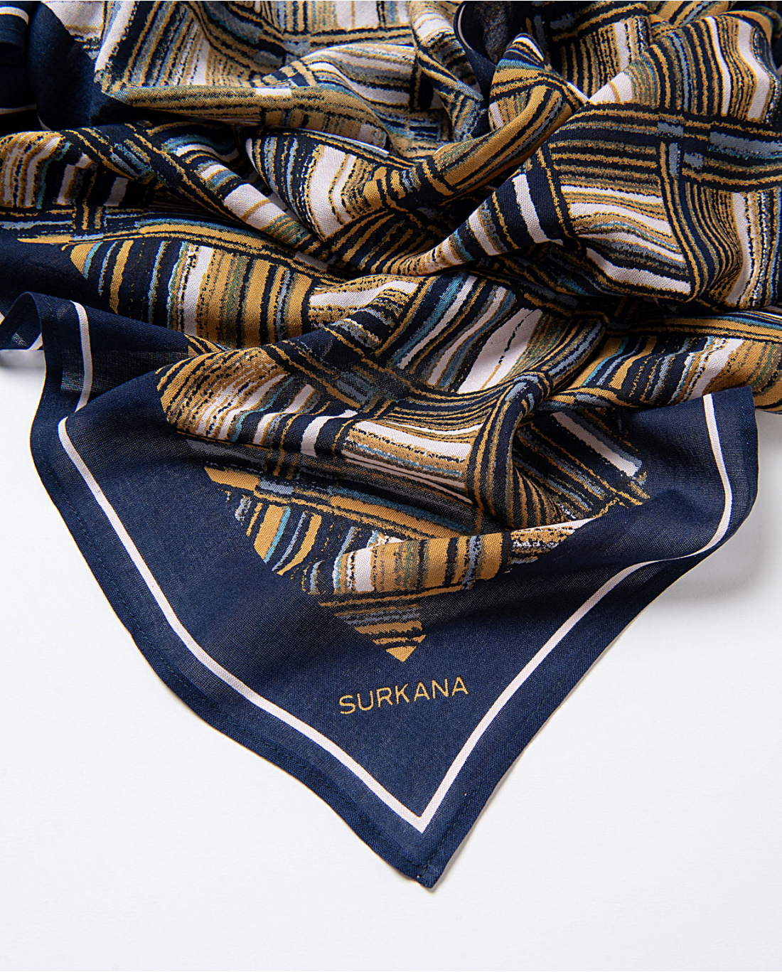 Women’s abstract geometric print scarf by Surkana with navy border and mustard accents for chic everyday and smart casual styling.