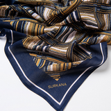 Women’s abstract geometric print scarf by Surkana with navy border and mustard accents for chic everyday and smart casual styling.