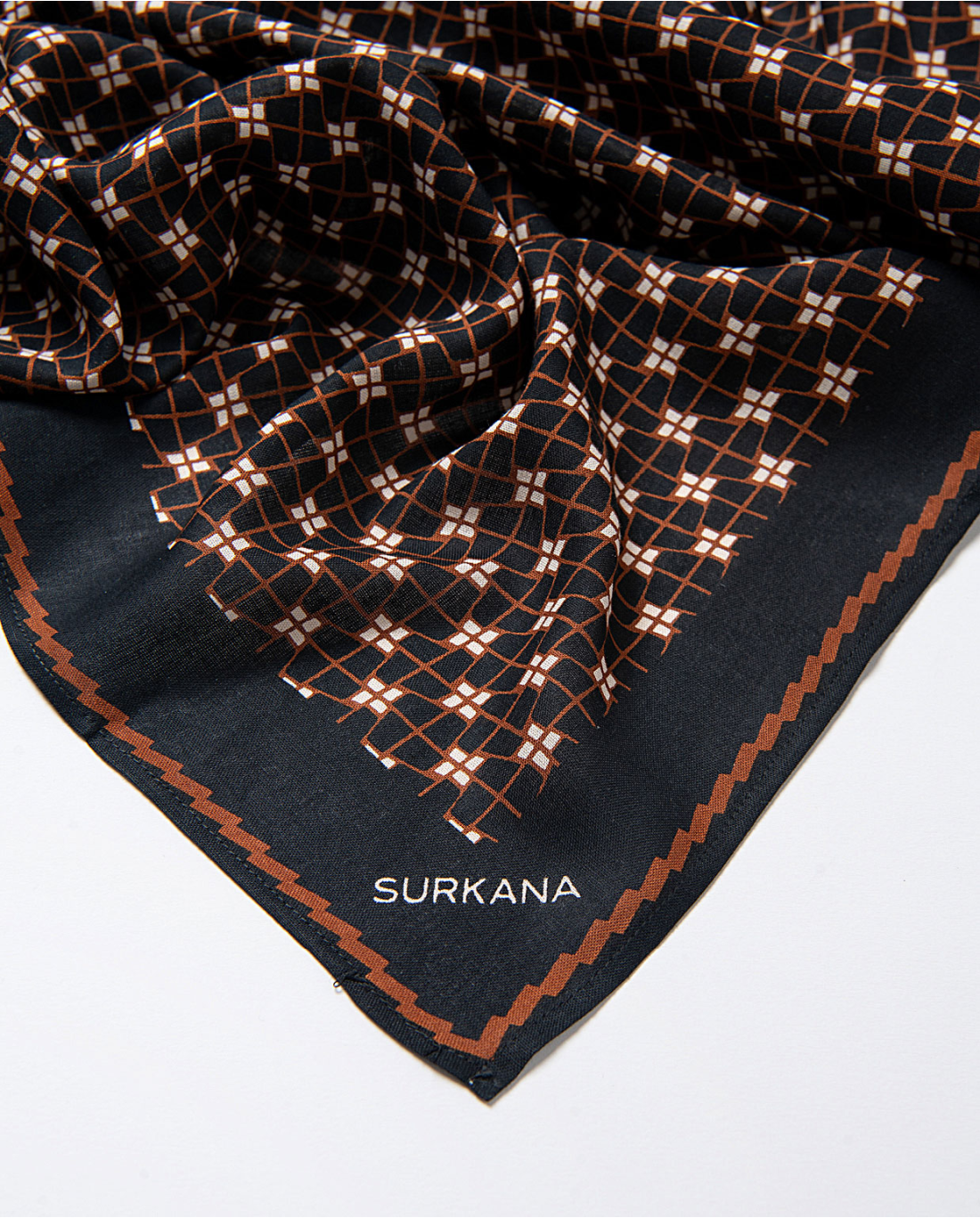 Surkana black fashion scarf with rust grid pattern for women’s modern casual and smart casual outfits.