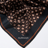 Surkana black fashion scarf with rust grid pattern for women’s modern casual and smart casual outfits.