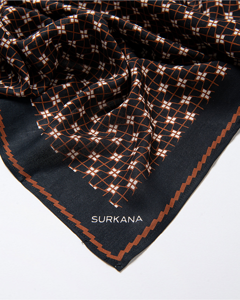 Surkana black fashion scarf with rust grid pattern for women’s modern casual and smart casual outfits.