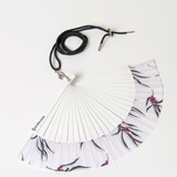 Chic folding fan accessory with minimalist floral print and lightweight design for warm-weather fashion and vacations.