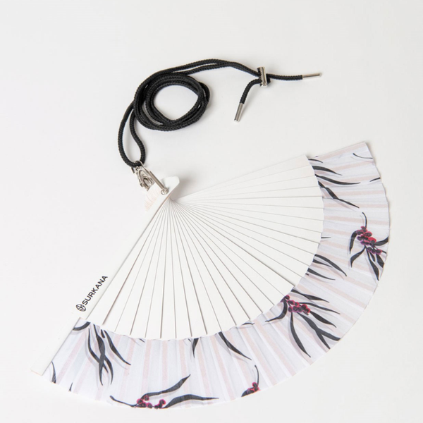 Chic folding fan accessory with minimalist floral print and lightweight design for warm-weather fashion and vacations.