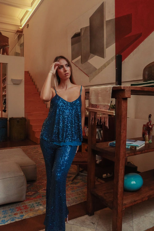 Glamorous blue sequin cami top with lightweight draped fit and sparkling embellishments for festive evening looks.
