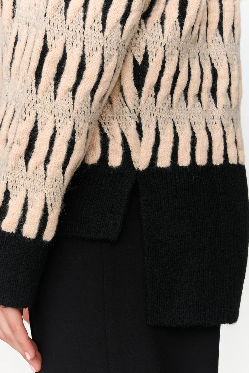 Trendy women’s zebra print knit sweater in cream and black for chic casual and elevated everyday outfits.