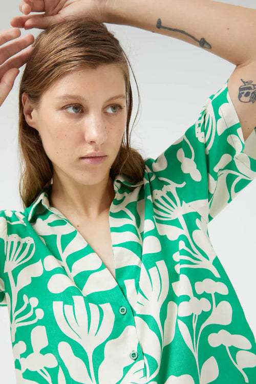 Chic green and white printed button-front top with breezy fit and elevated casual summer fashion vibe.