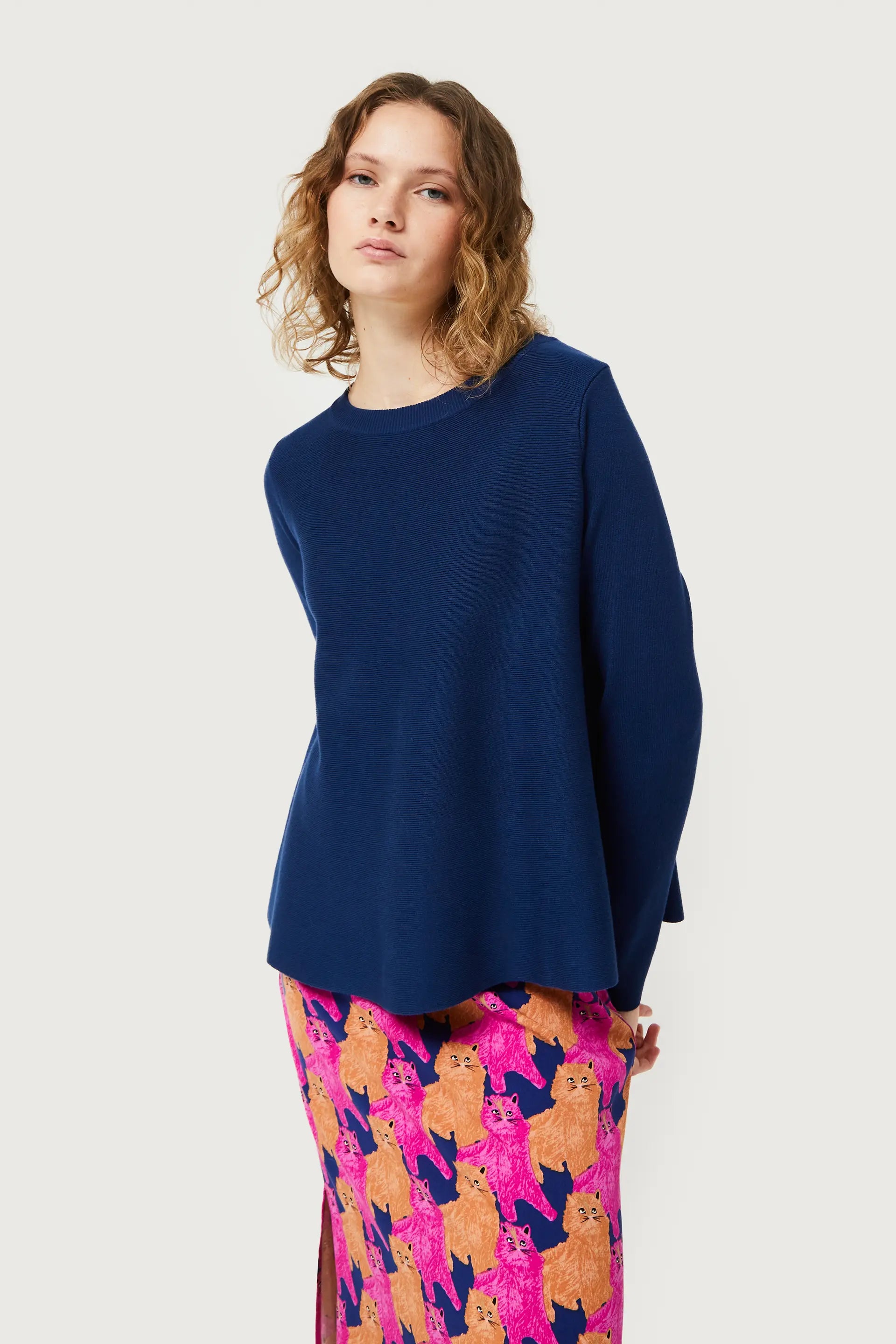 Trendy women’s navy knit top with modern clean lines and playful artistic print fashion statement bottoms.