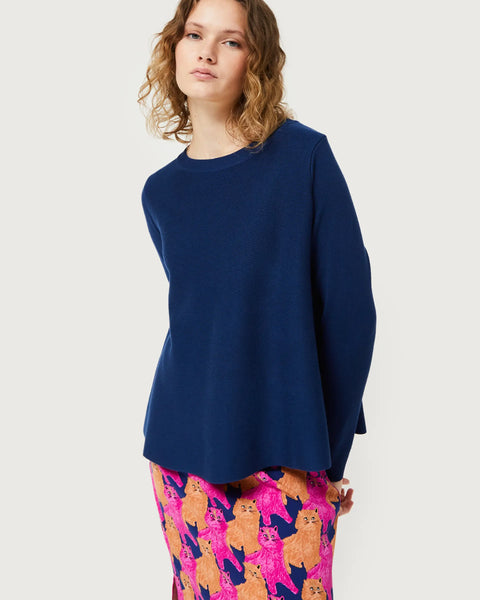 Trendy women’s navy knit top with modern clean lines and playful artistic print fashion statement bottoms.