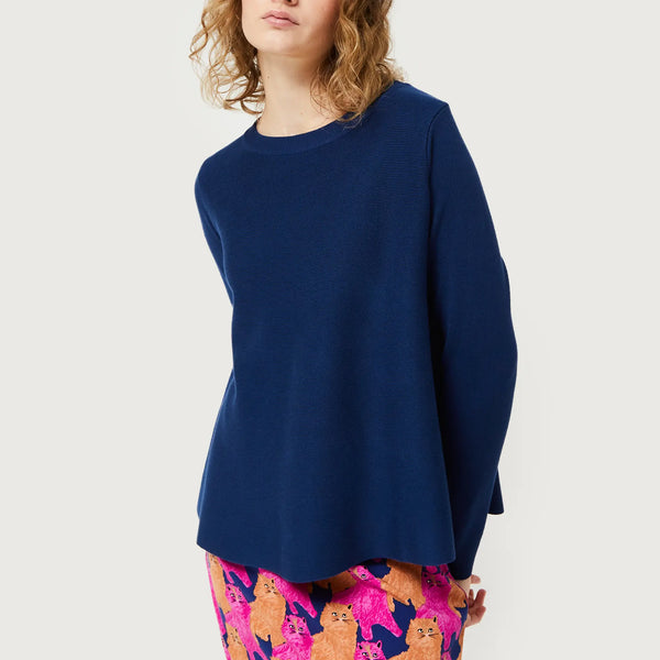 Trendy women’s navy knit top with modern clean lines and playful artistic print fashion statement bottoms.