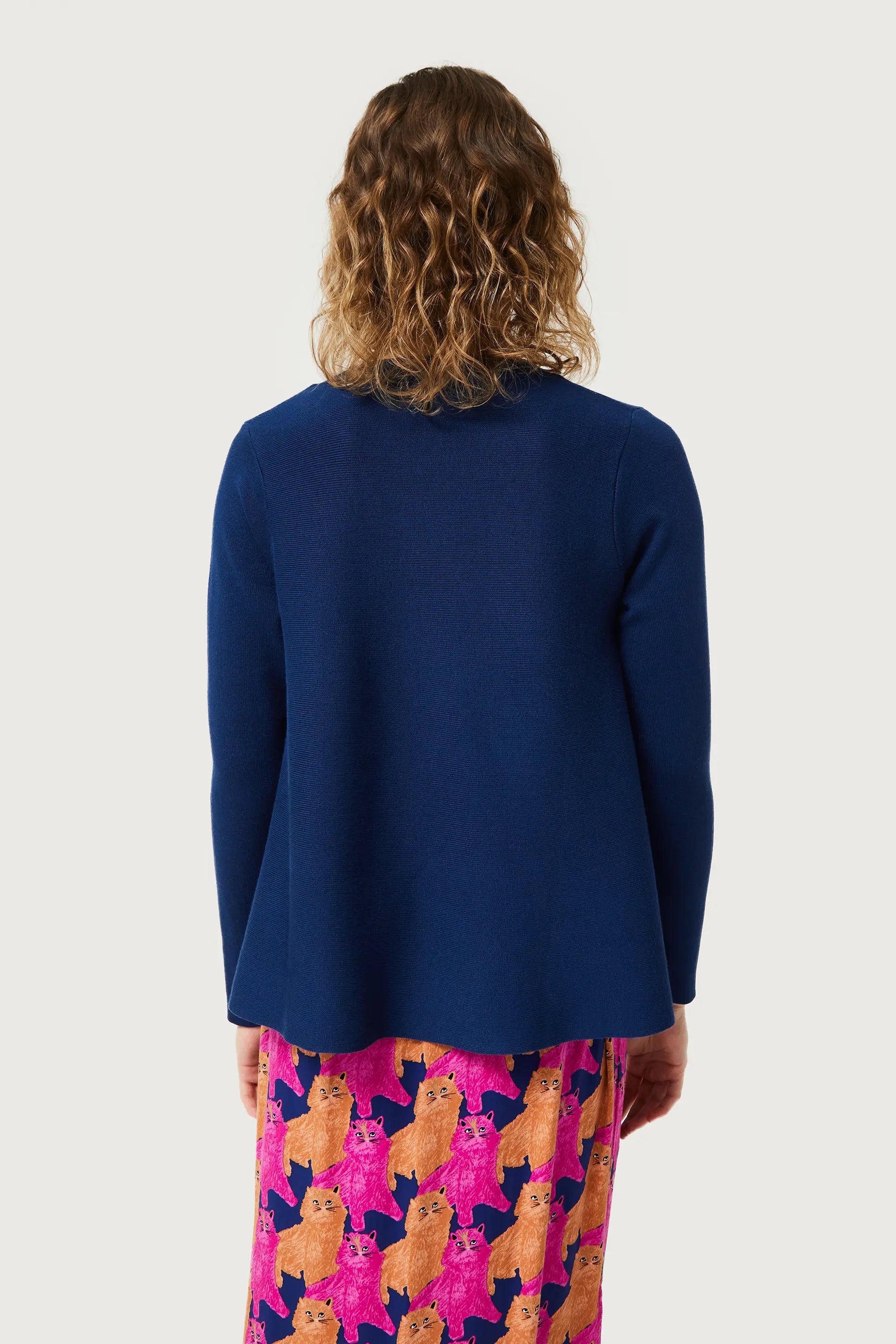 Women’s navy blue knit sweater with minimalist silhouette and playful cat print pants for modern casual fashion.