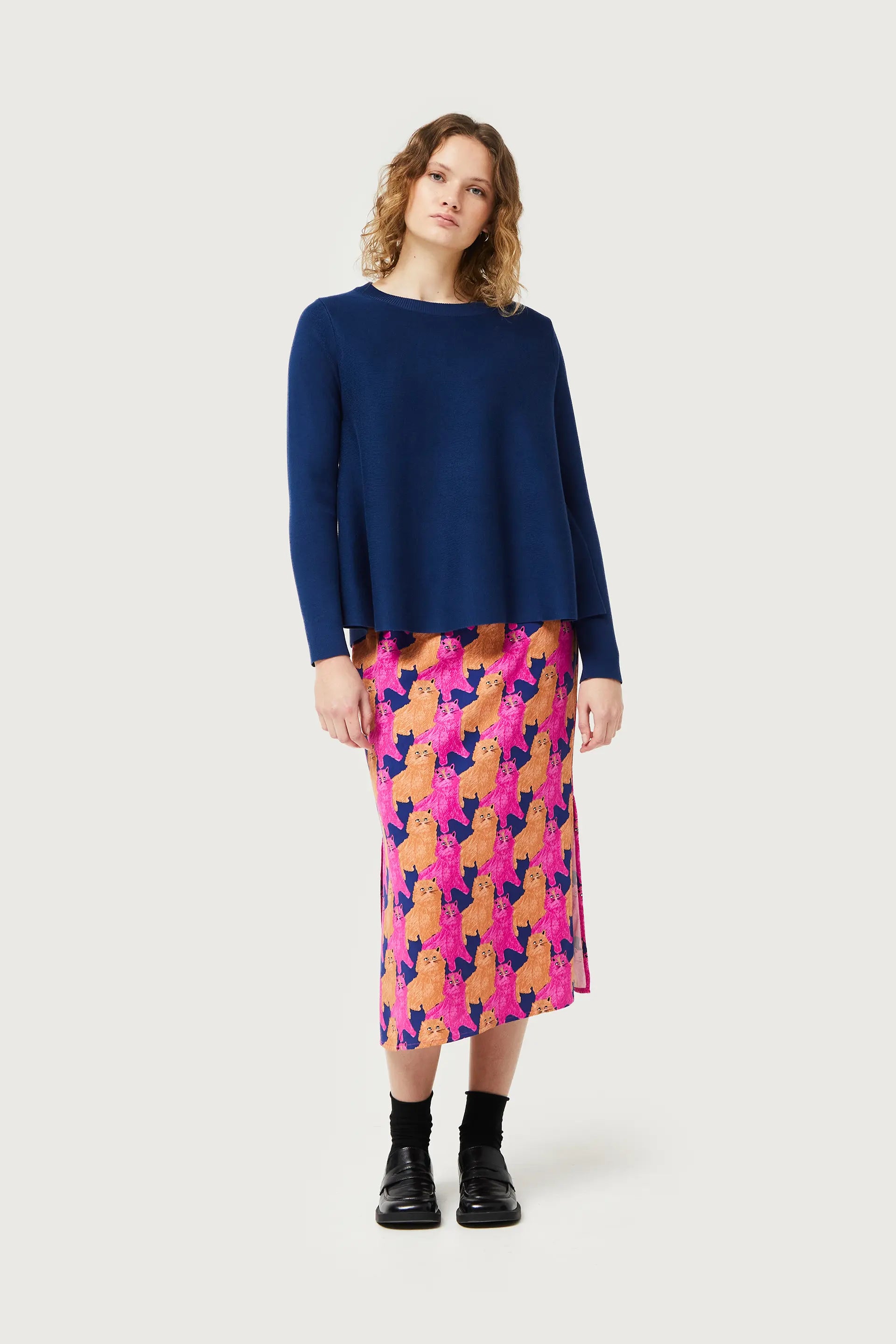 Cozy navy blue pullover sweater with modern oversized fit and artistic statement print loungewear aesthetic.