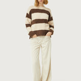 Contemporary fuzzy stripe sweater in neutral tones with relaxed fit and timeless cold-weather fashion style.