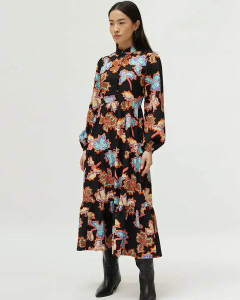 Women’s black floral maxi dress with vibrant abstract print and modern boho chic fashion styling.