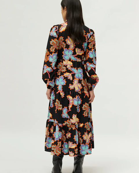 Modern black floral tiered dress with relaxed fit and elevated casual-to-evening fashion styling.