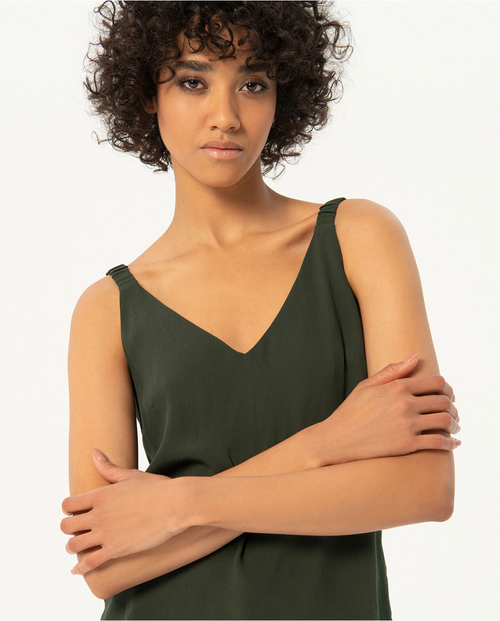 Casual luxe forest green camisole featuring subtle side slit detail and breezy relaxed fit for sophisticated summer dressing.