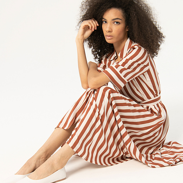 Resort-inspired striped button-front dress with relaxed fit and elegant vertical pattern for effortless vacation and city dressing.