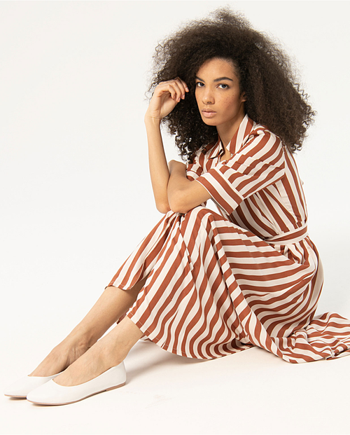 Resort-inspired striped button-front dress with relaxed fit and elegant vertical pattern for effortless vacation and city dressing.