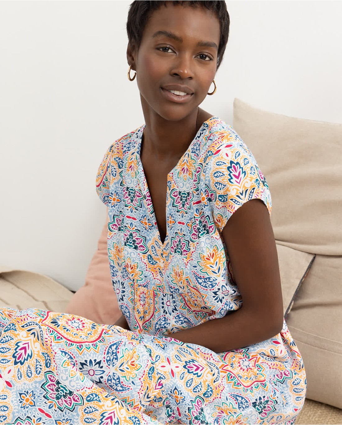 Fashion-forward boho maxi dress with flutter sleeves and lightweight flowy silhouette for summer occasions.