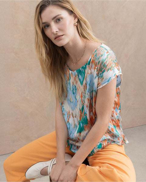 Women’s flowy short sleeve top with vibrant brushstroke print and easy everyday elegance.