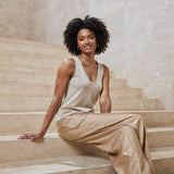 Lightweight beige shimmer sleeveless top featuring a soft metallic finish and relaxed silhouette for vacations, dinners and special occasions.