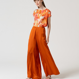 Women's rust orange full-length palazzo trousers with wide legs and a flattering high-waisted silhouette.