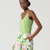 Fashionable women’s resort fashion set with flowy printed trousers and fresh lime green camisole top
