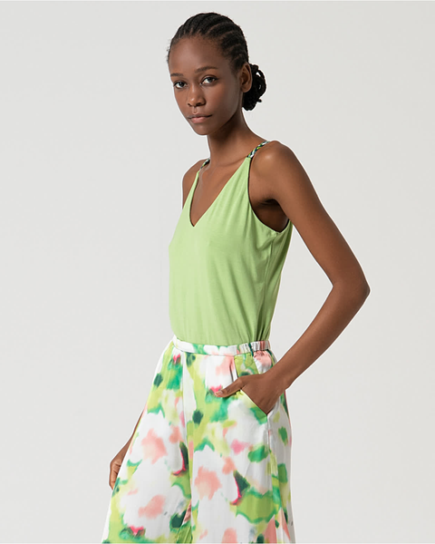 Fashionable women’s resort fashion set with flowy printed trousers and fresh lime green camisole top