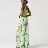 Stylish abstract print wide leg trousers paired with trendy green camisole for elevated casual resort fashion.