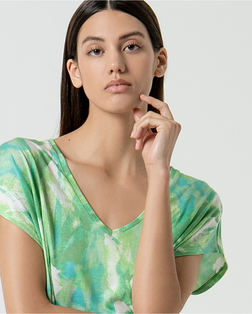 Trendy green tie-dye inspired short sleeve top with modern artistic print and relaxed summer silhouette.