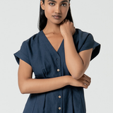 Minimalist navy midi dress with rolled sleeves and flattering relaxed tailored fit for everyday elegance.