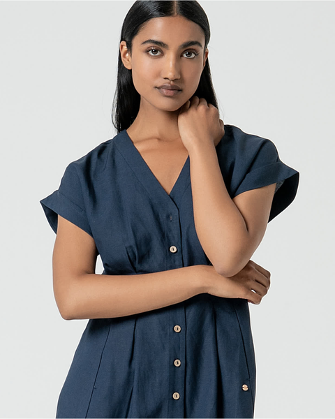 Minimalist navy midi dress with rolled sleeves and flattering relaxed tailored fit for everyday elegance.