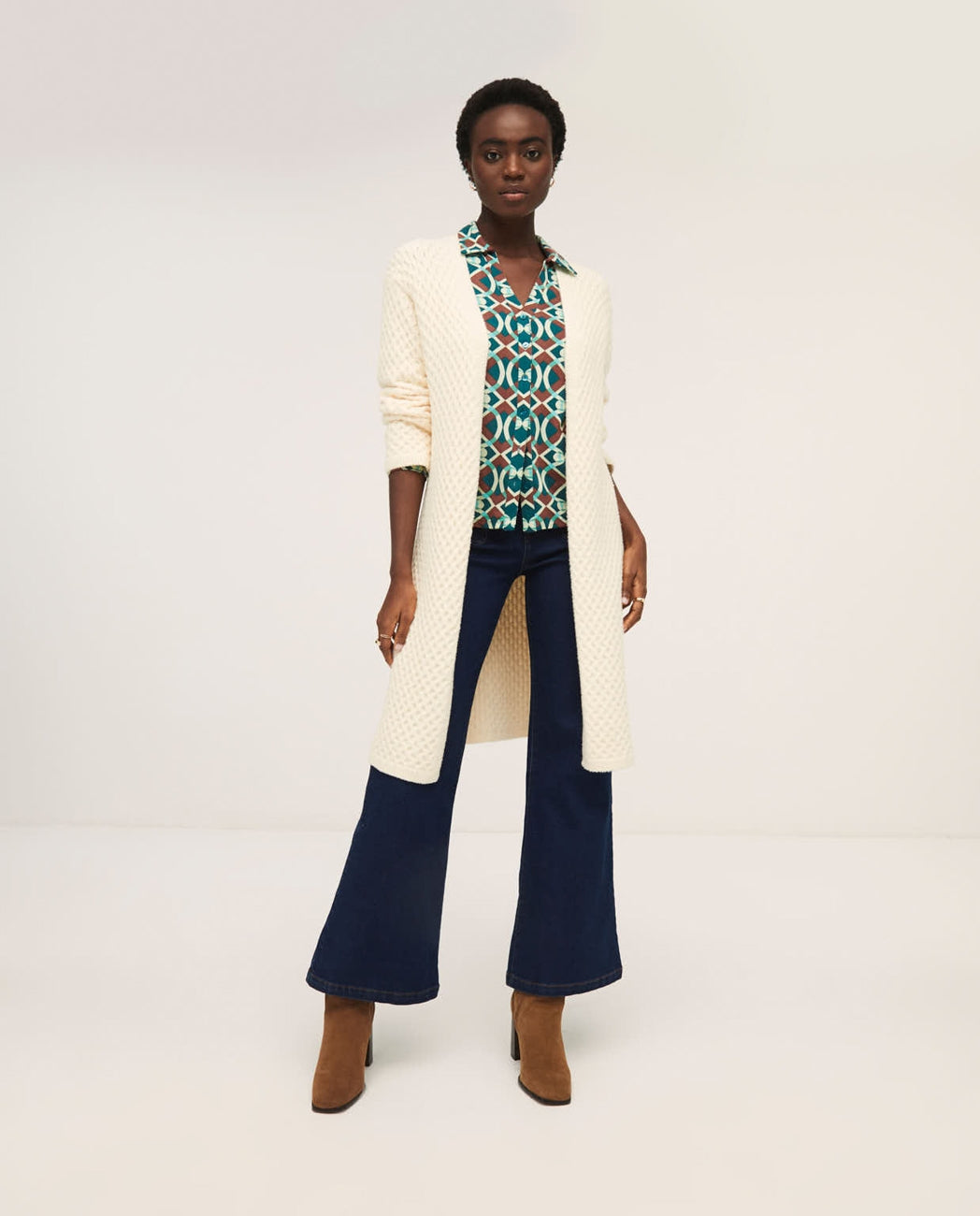 Soft cream open-front duster cardigan with lightweight knit construction and elegant relaxed fit.