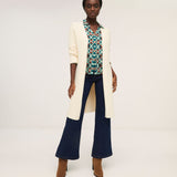 Soft cream open-front duster cardigan with lightweight knit construction and elegant relaxed fit.
