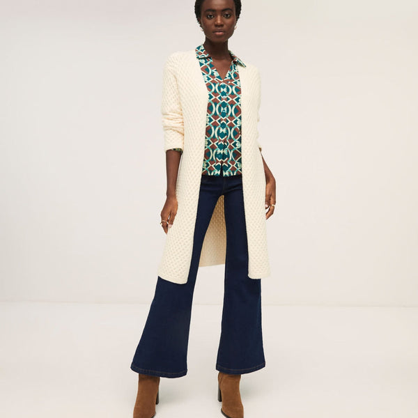 Soft cream open-front duster cardigan with lightweight knit construction and elegant relaxed fit.