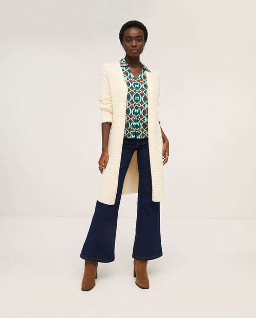 Soft cream open-front duster cardigan with lightweight knit construction and elegant relaxed fit.