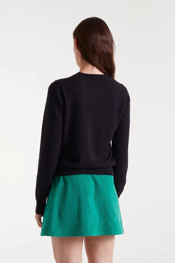 Black button-front cardigan featuring colorful heart buttons in pink, blue, green and red for fun contemporary women's style.