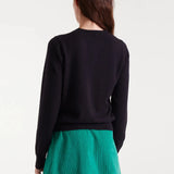 Black button-front cardigan featuring colorful heart buttons in pink, blue, green and red for fun contemporary women's style.
