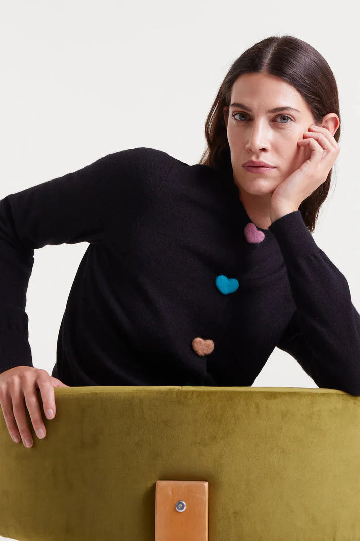 Playful women's black crew neck cardigan with multicolor heart buttons and lightweight knit texture for contemporary boutique fashion.