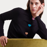 Playful women's black crew neck cardigan with multicolor heart buttons and lightweight knit texture for contemporary boutique fashion.