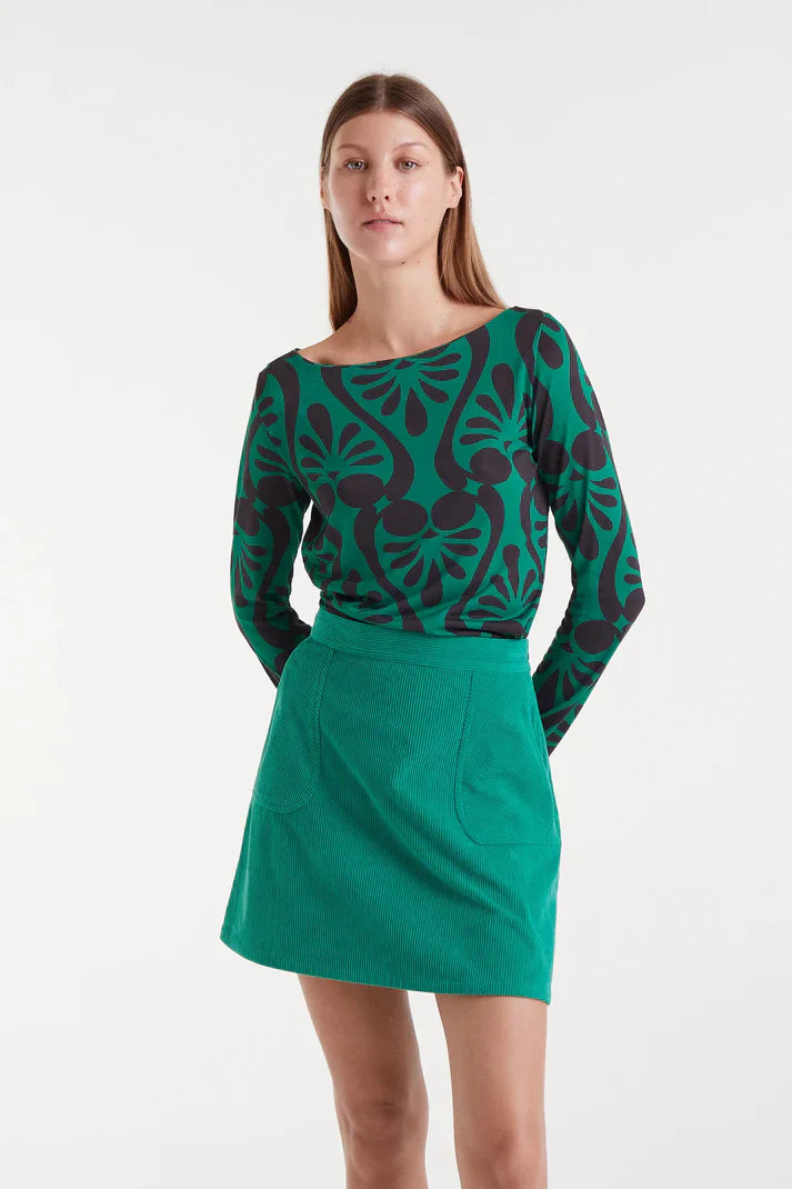 Women’s green and black abstract print top with long sleeves and boat neckline for bold statement outfits and modern everyday style.