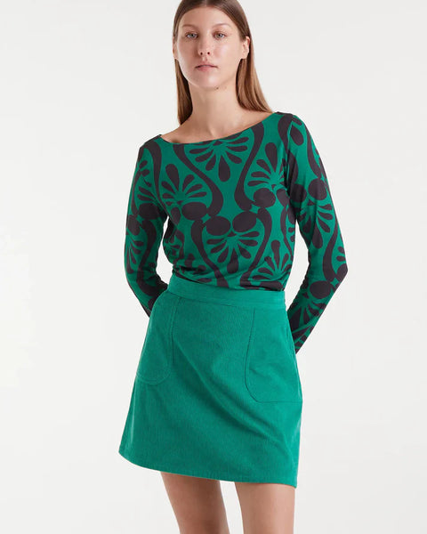 Women’s green and black abstract print top with long sleeves and boat neckline for bold statement outfits and modern everyday style.