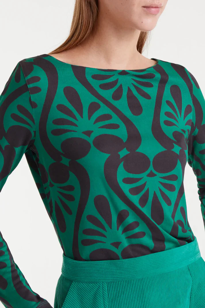 Women’s green and black graphic print top with long sleeves and boat neckline for modern casual fashion.