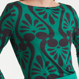Women’s green and black graphic print top with long sleeves and boat neckline for modern casual fashion.