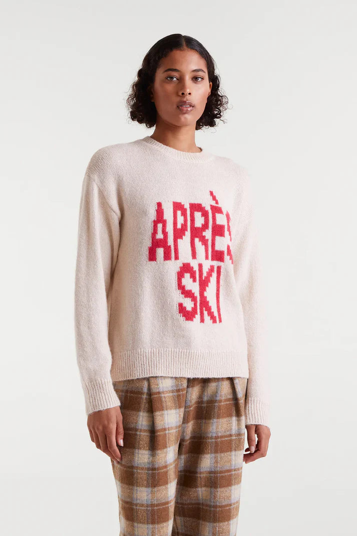 Women's Après Ski sweater in cream with bold red graphic lettering, cozy crew neck knit for winter and ski resort outfits.