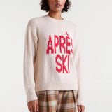 Women's Après Ski sweater in cream with bold red graphic lettering, cozy crew neck knit for winter and ski resort outfits.