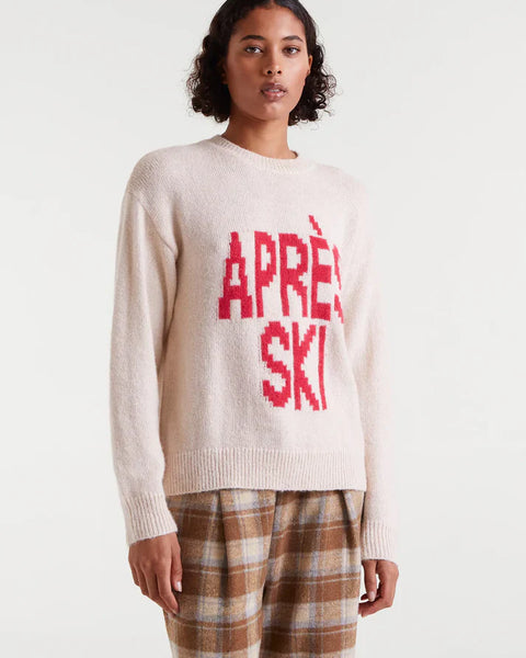 Women's Après Ski sweater in cream with bold red graphic lettering, cozy crew neck knit for winter and ski resort outfits.
